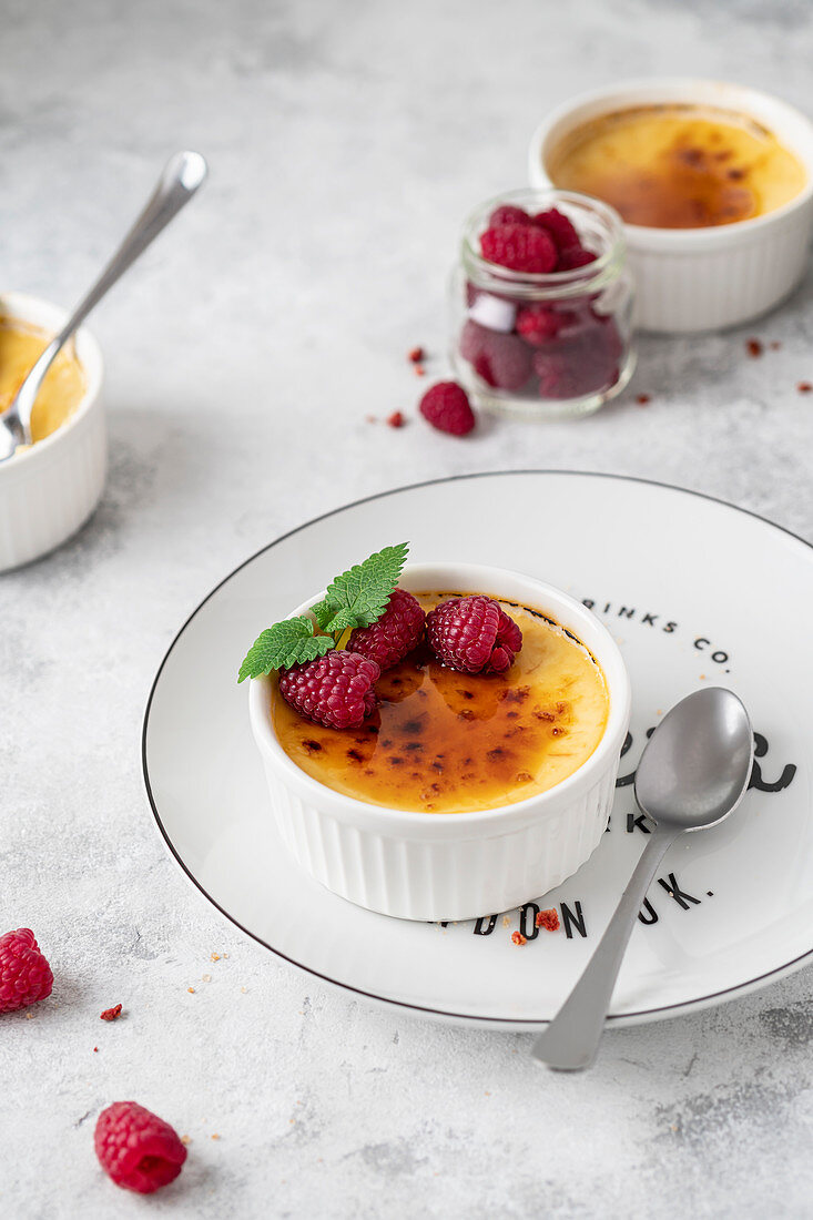 Cream brulee with raspberries and mint