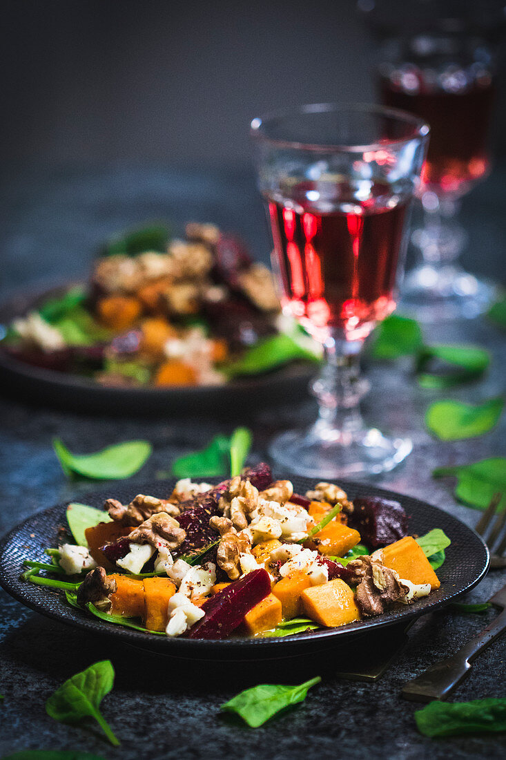 Sweet potato salad with spinach, honey, beetroot, goat cheese and walnuts