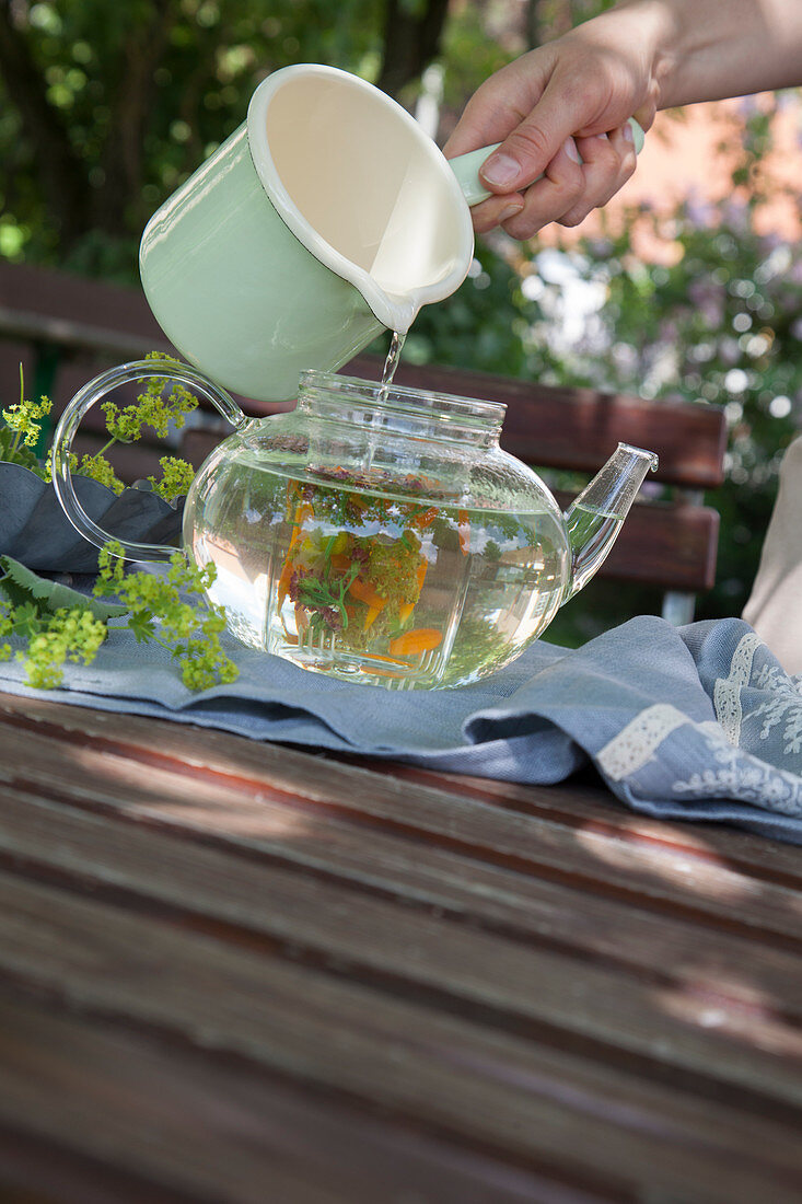 Brewing flower tea in a glass jug