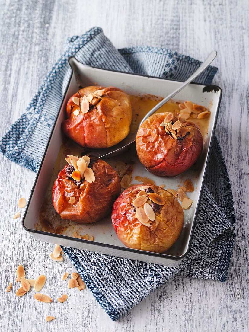 Stuffed baked apple with Dominostein and flaked almonds