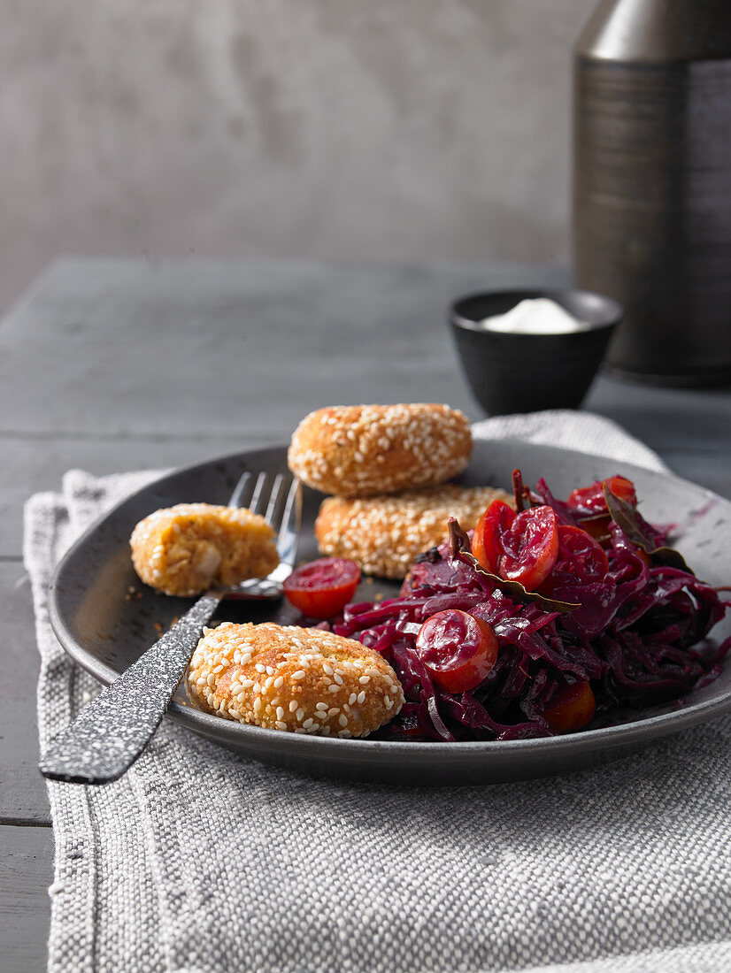 Chickpea dumplings wrapped in sesame seeds with braised red cabbage