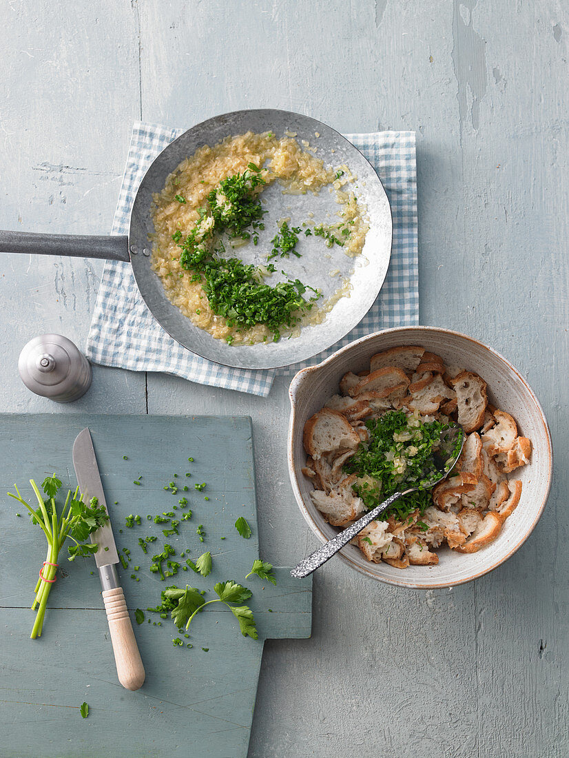 Seasoning sliced bread rolls with onions and parsley