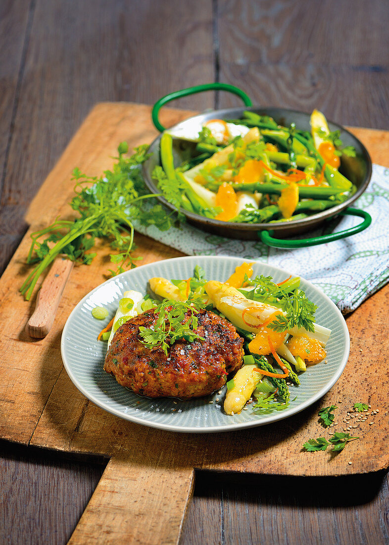 Herb fritters on an asparagus and orange salad