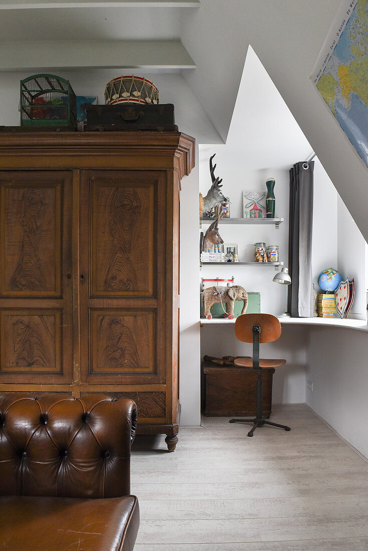 An antique wardrobe next to writing nook