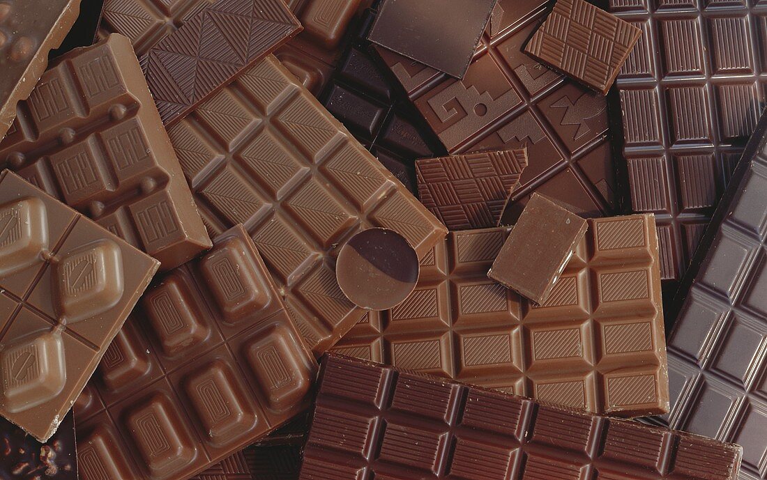 Many different bars of chocolate and chocolate penny