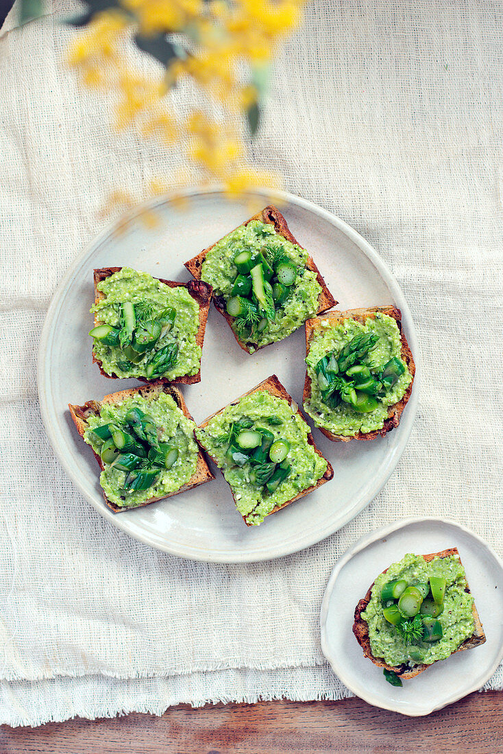 Herbed broad bean and feta crostini with asparagus