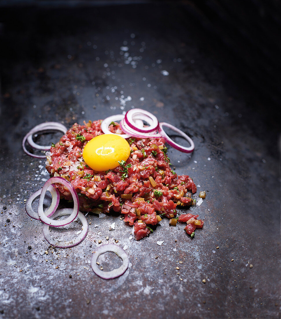 Classic beef tartare with gherkins, onions and egg yolk