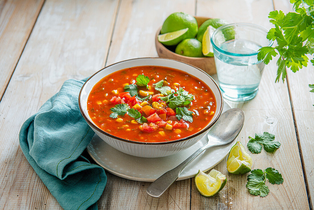 Spicy mexican coen and pepper soup with lime and coriander
