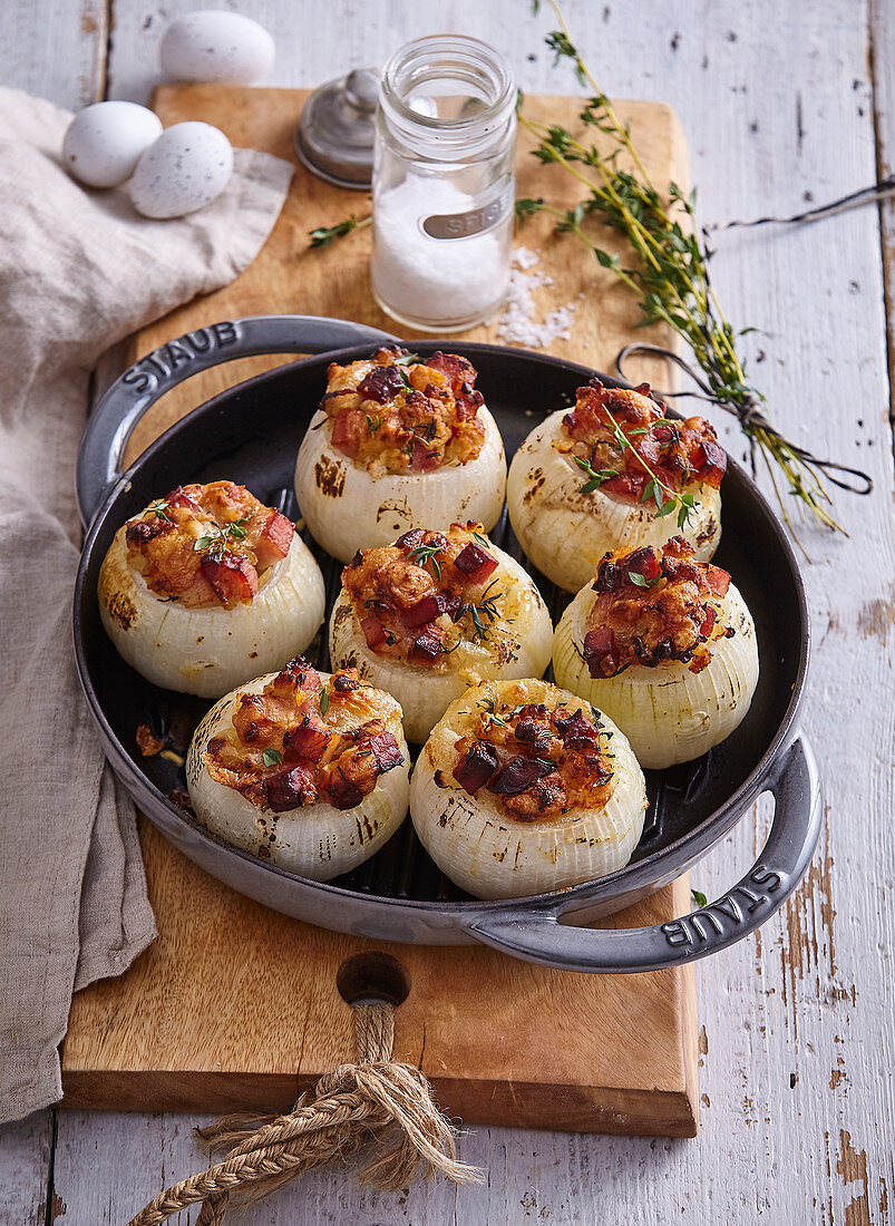 Baked onion with sour milk cheese and bacon stuffing