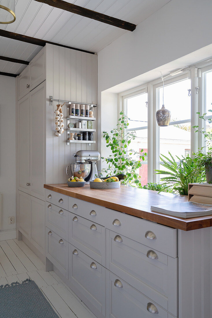 Weiße Küche mit Holzarbeitsplatte in skandinavischem Stil