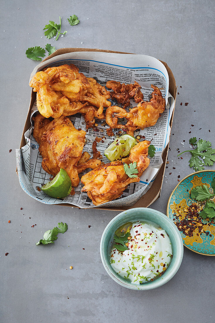 Curry and chilli onion bhajis with a lime and yoghurt dip