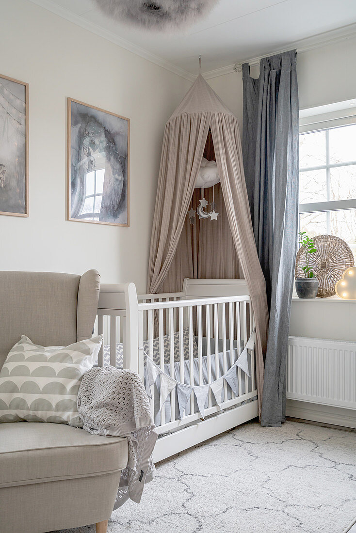 An upholstered armchair and a cot with a canopy