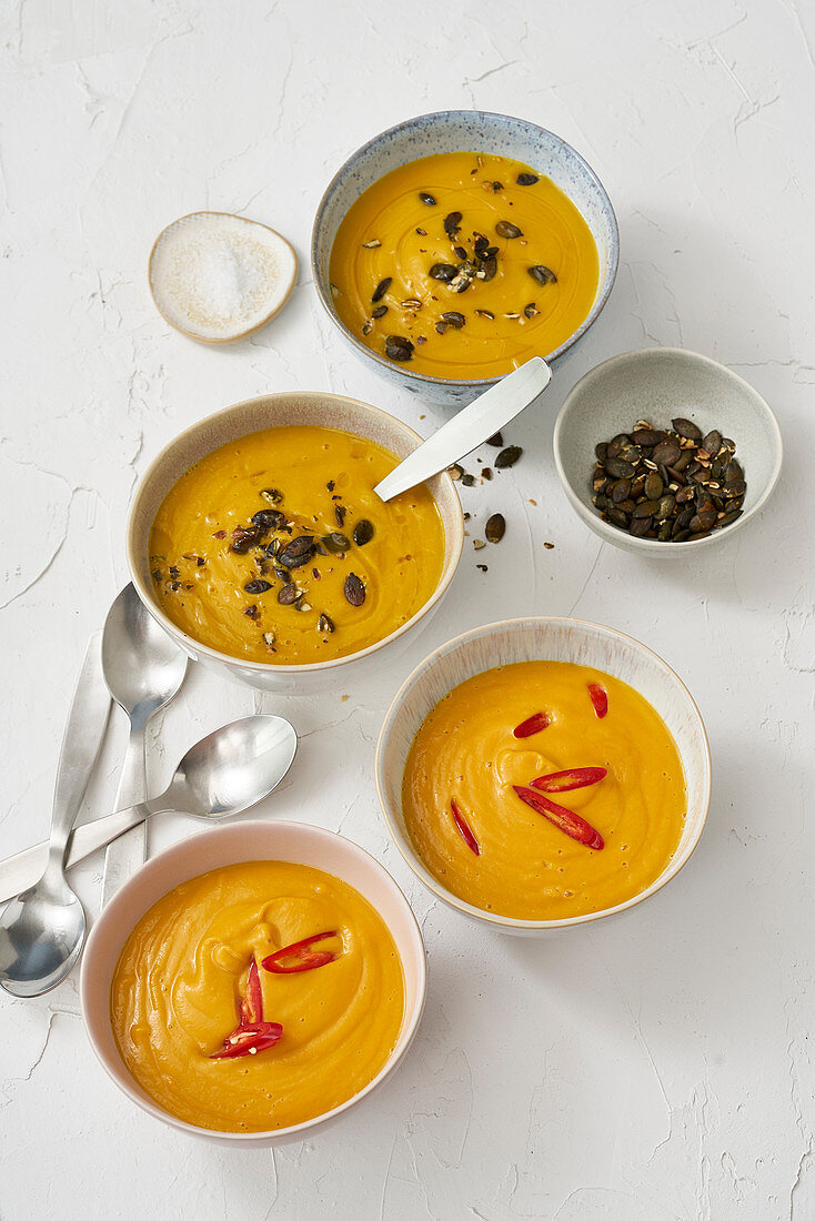 Cauliflower and carrot soup and curry-sweet potato soup