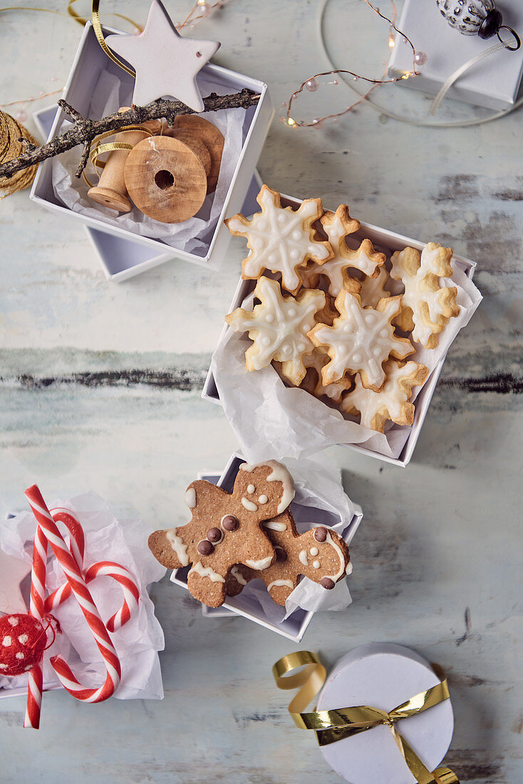 Gingerbread people and butter biscuits in gift boxes