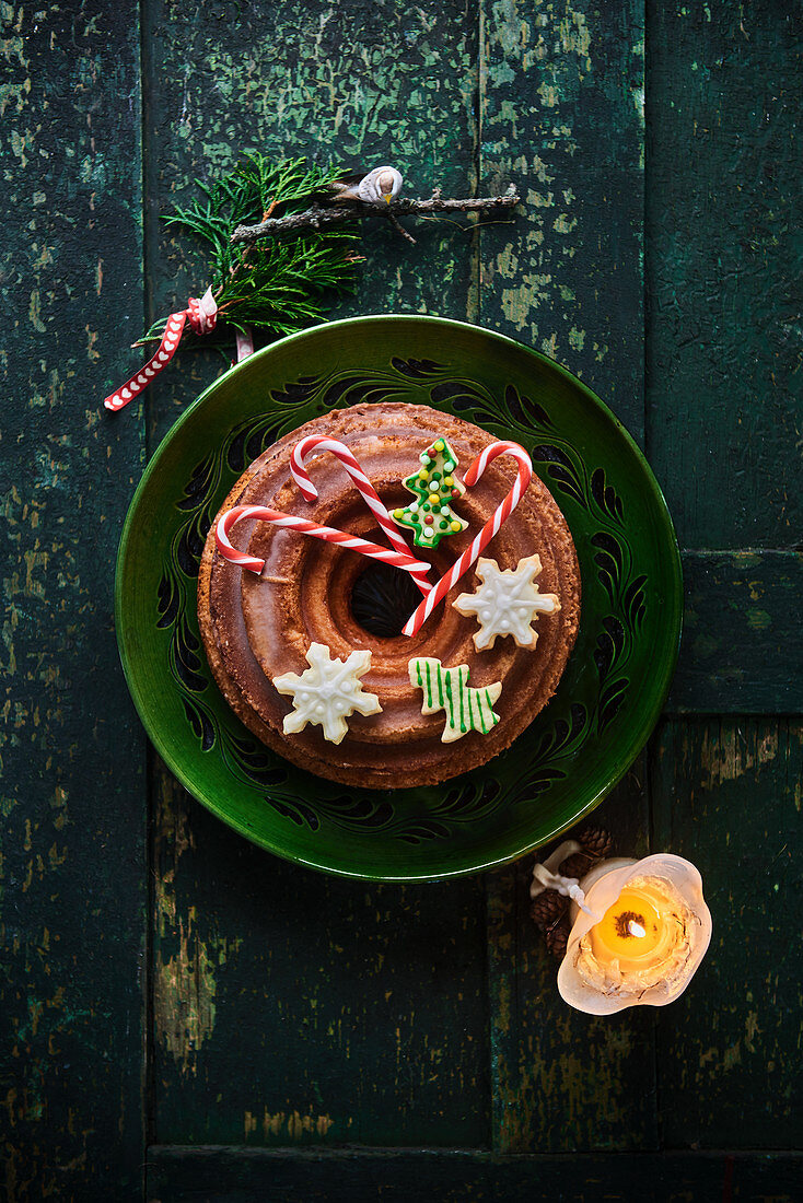 A lemon Bundt cake decorated with butter biscuits and candy canes