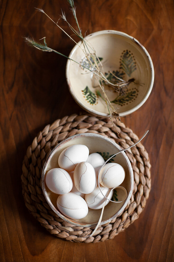 Easter eggs colored with coffee and decorated with cosmetic pencil