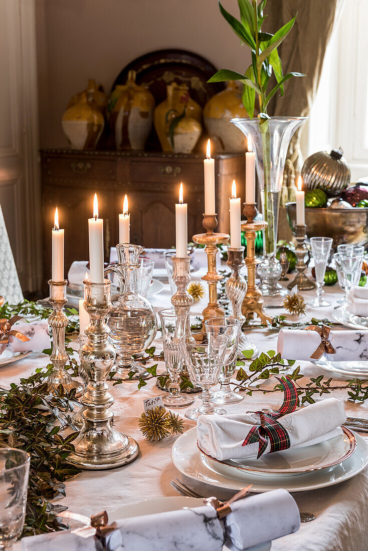 Christmas table festively set with mercury glass candlesticks