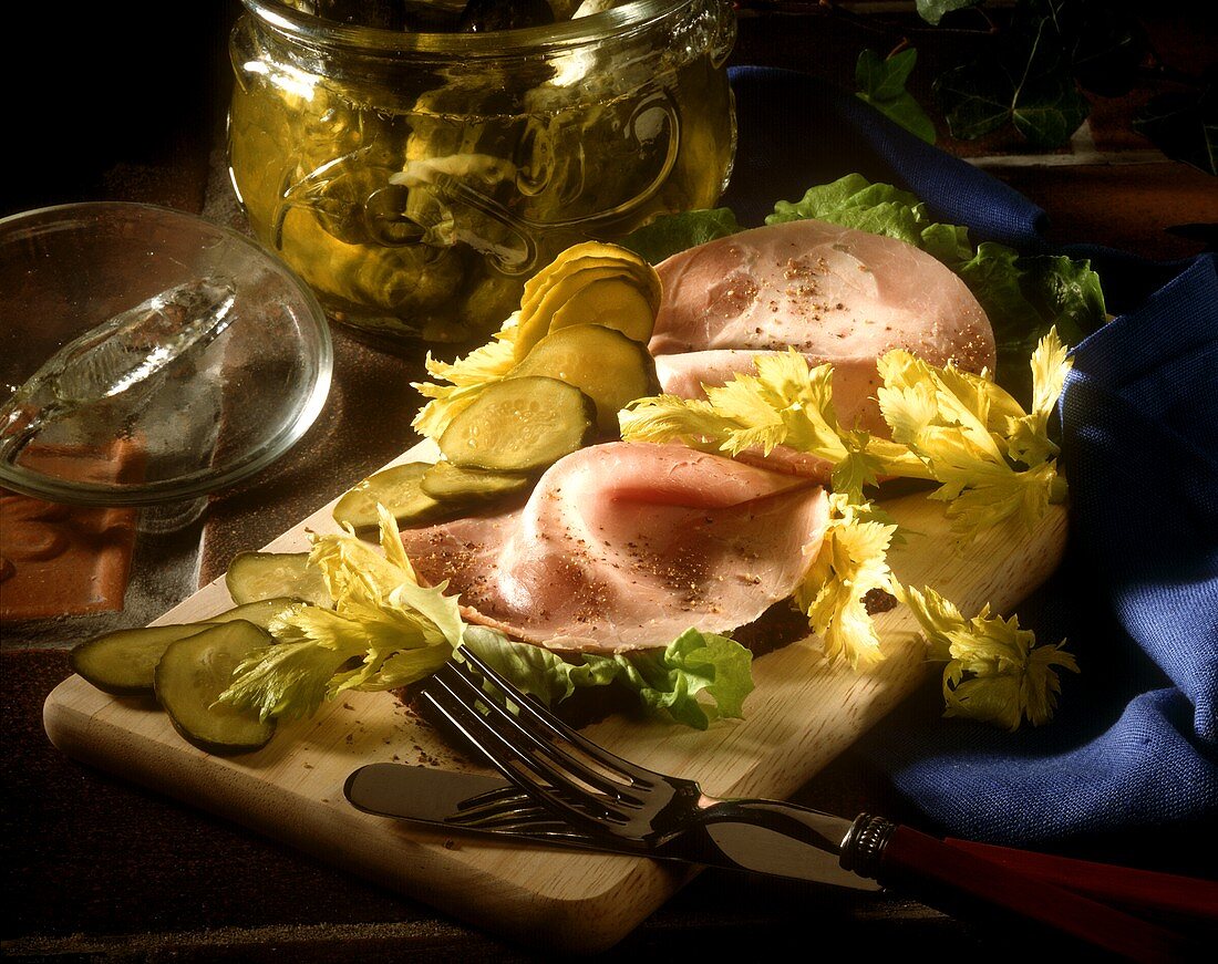 Two open sandwiches with ham, salad and gherkins