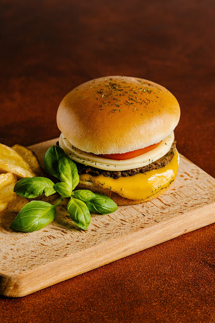 Cheese and beef burger with mustard barbecue sauce and french fries