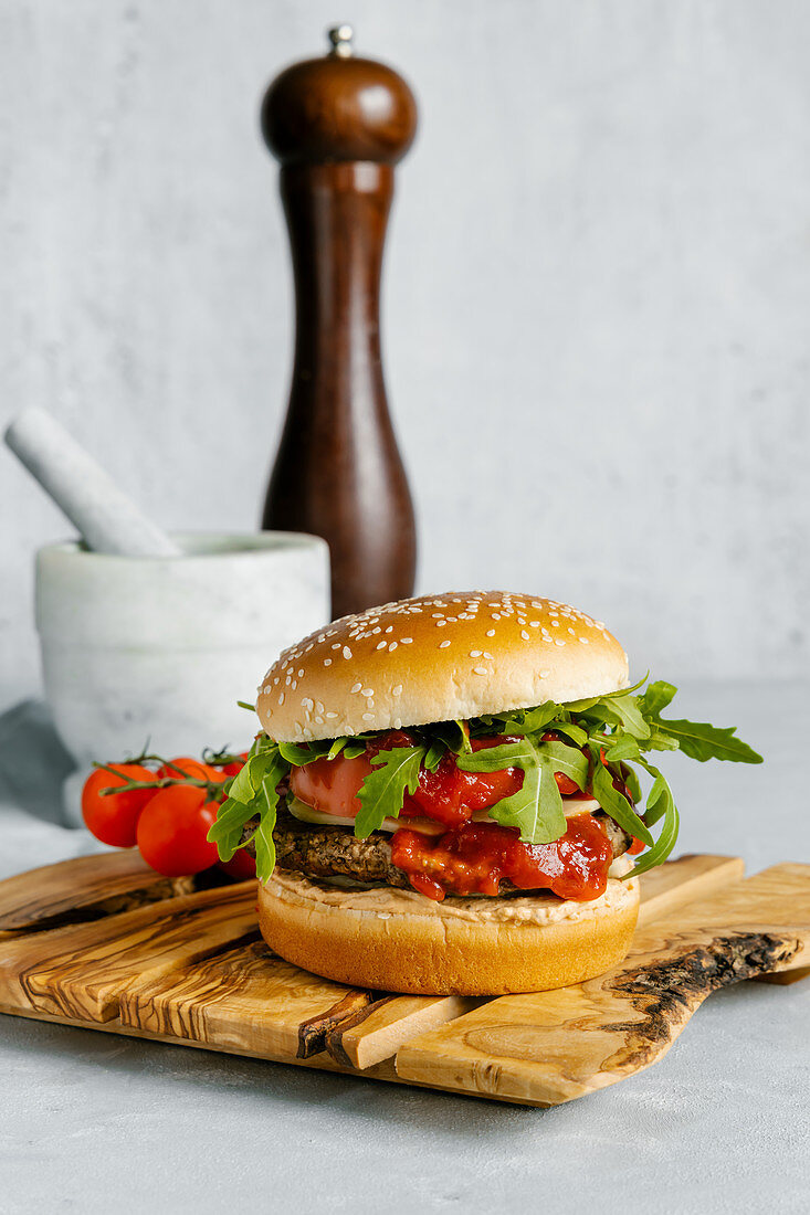 Spicy beef burger with arugula and white sesame bun