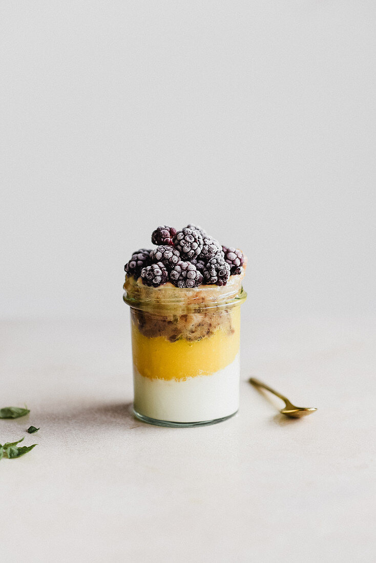 Mango mousse dessert with yogurt and blackberries