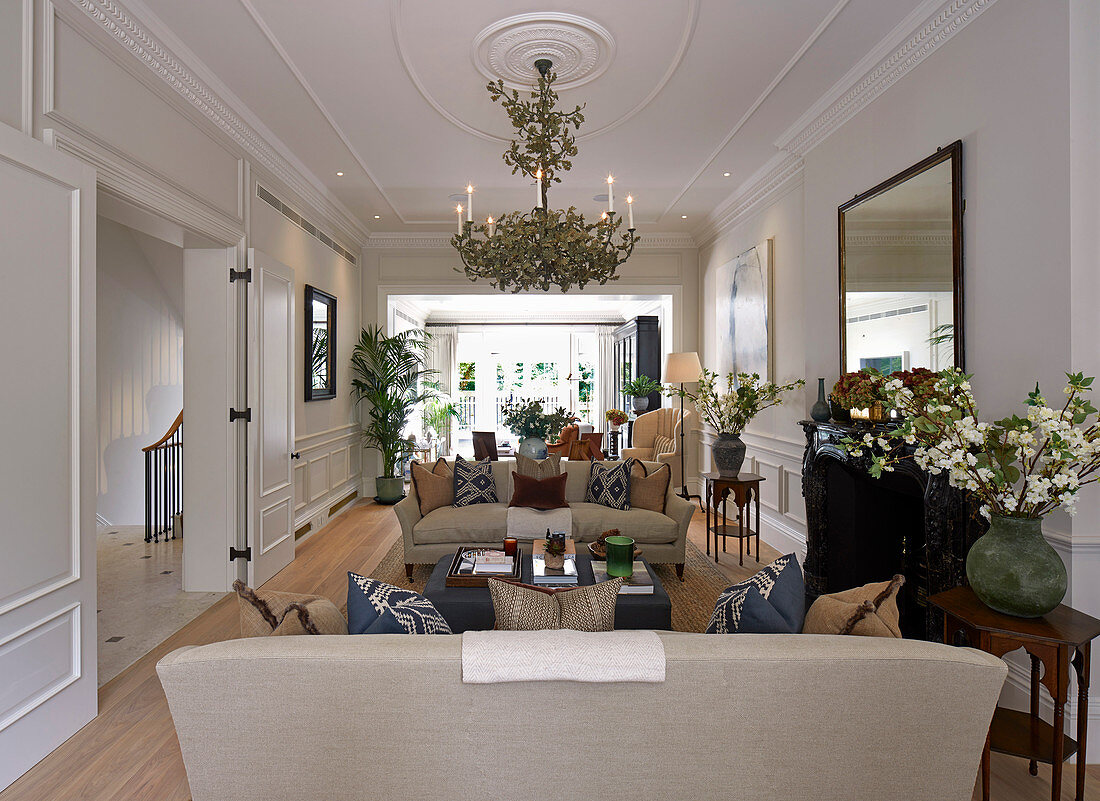 Elegant living room with panelled walls and stucco ceiling