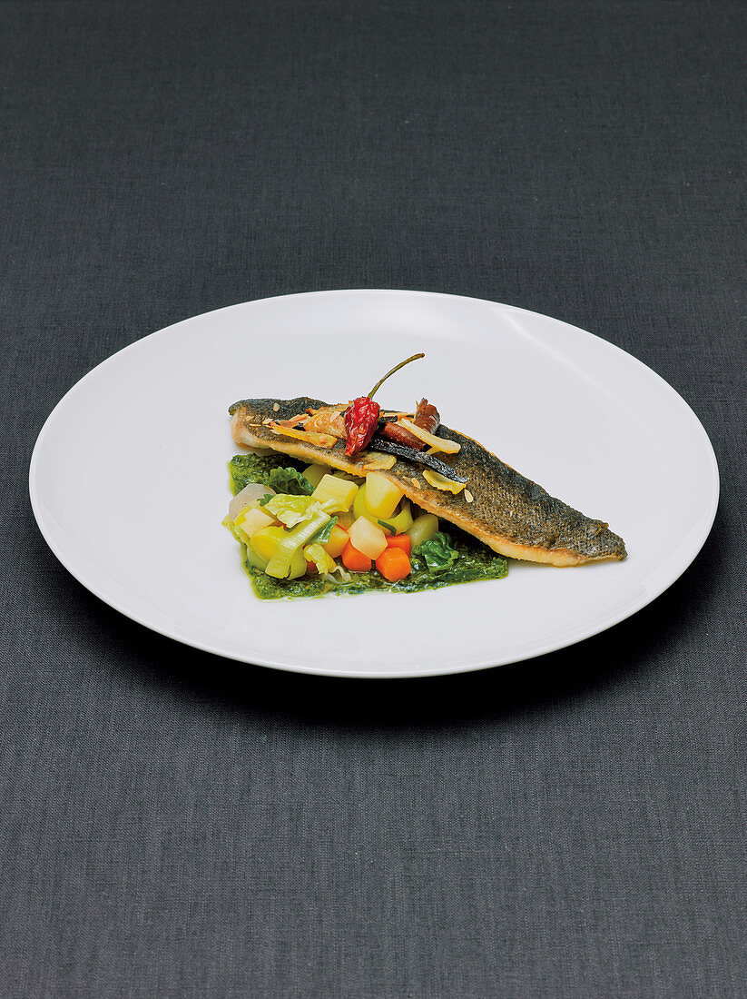 trout served on a bed of mixed vegetables