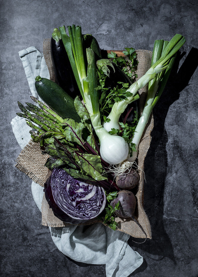 Still life with green and purple vegetables