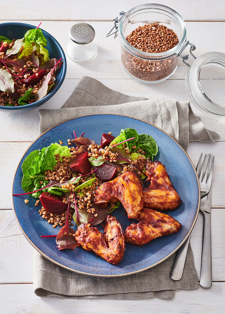 Spicy chicken wings with warm autumn salad