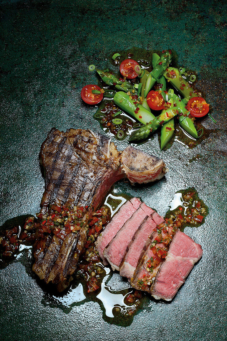 Porterhouse steak with chimichurri and green asparagus salad