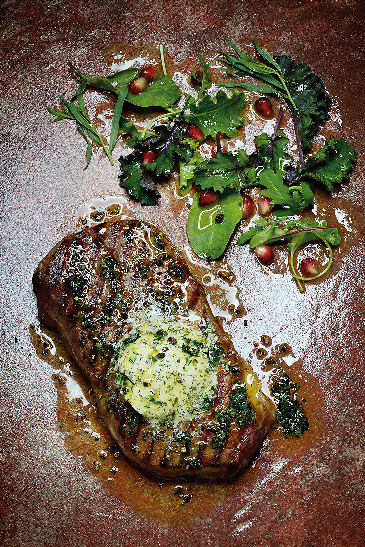 Grilled rump steak with herb butter and wild herb salad