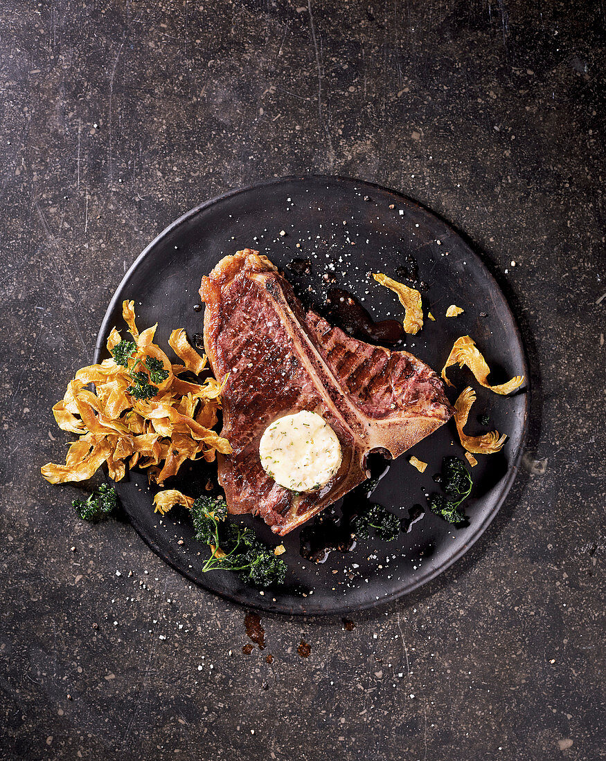 A T-bone steak with fried artichokes and marrow butter