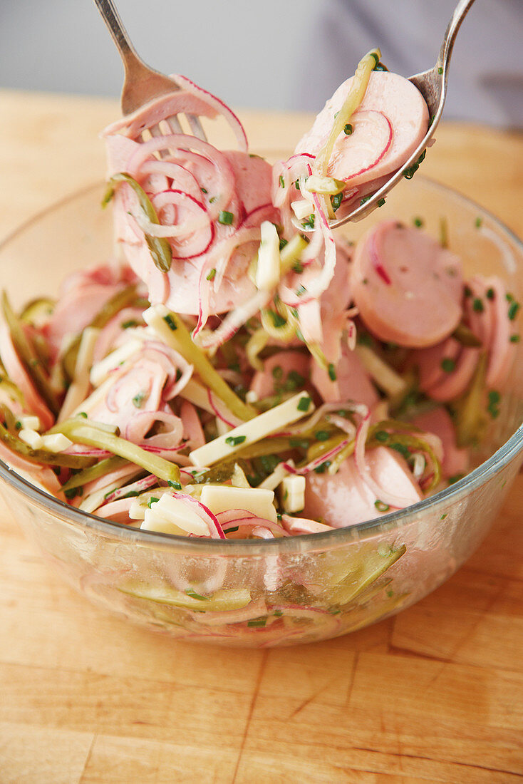 Swiss meat salad being mixed
