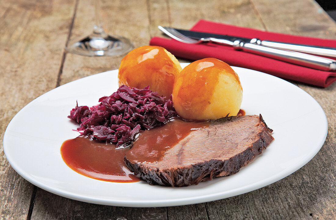 Sauerbraten (marinated pot roast) with dumplings and red cabbage