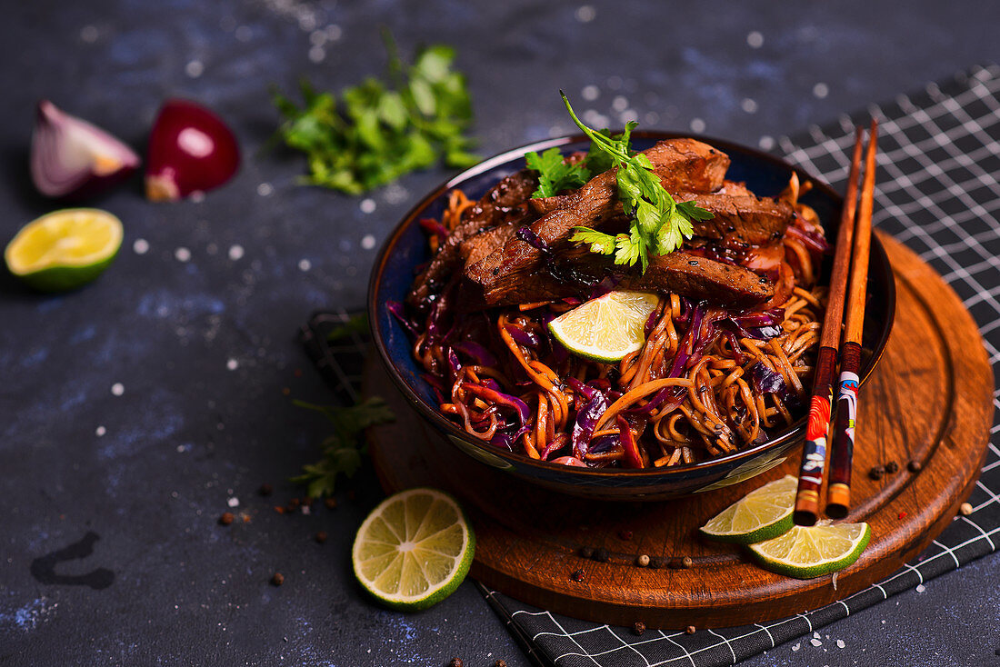 Asian cuisine soba noodles with red cabbage, beef and hoisin sauce