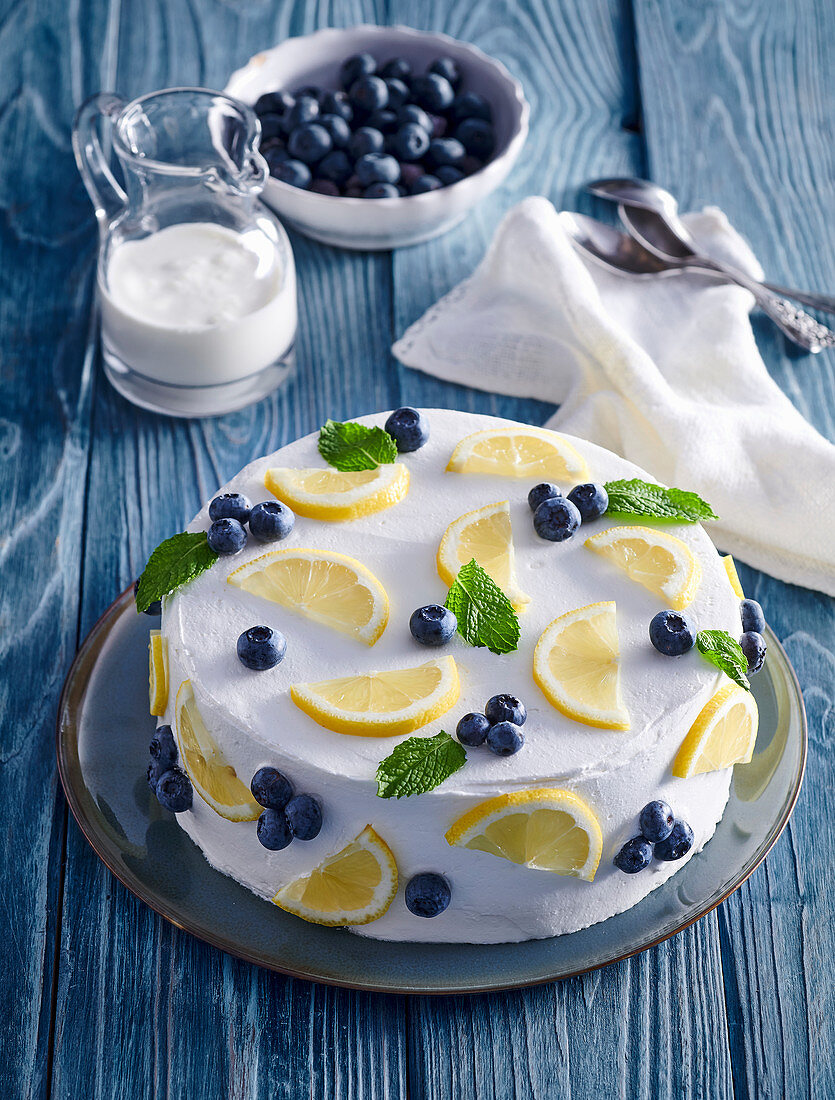 Cream cake with blueberries and lemons