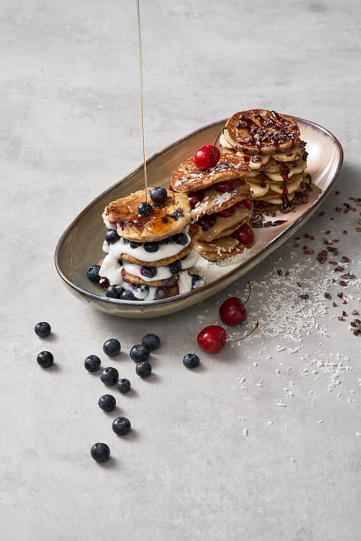 Variations of pancakes with blueberries, bananas and almonds