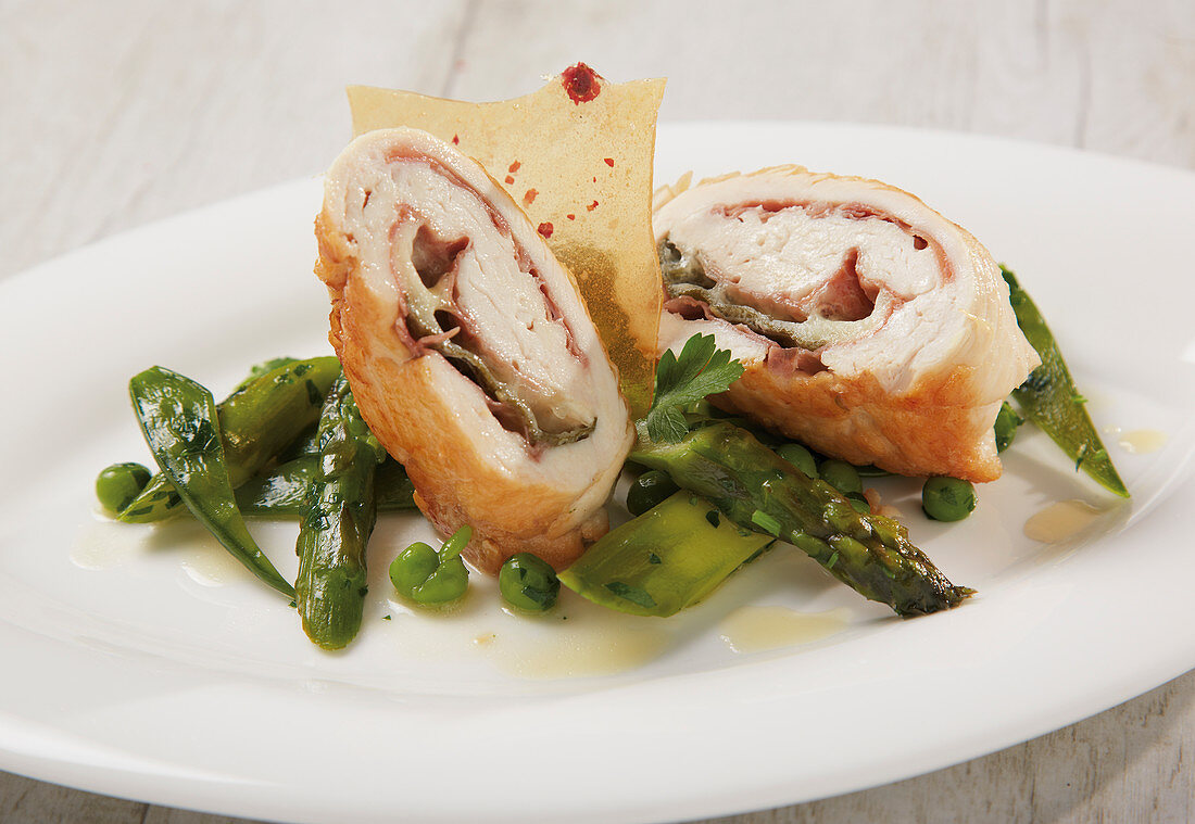 Chicken roulade with green asparagus, peas and mange tout