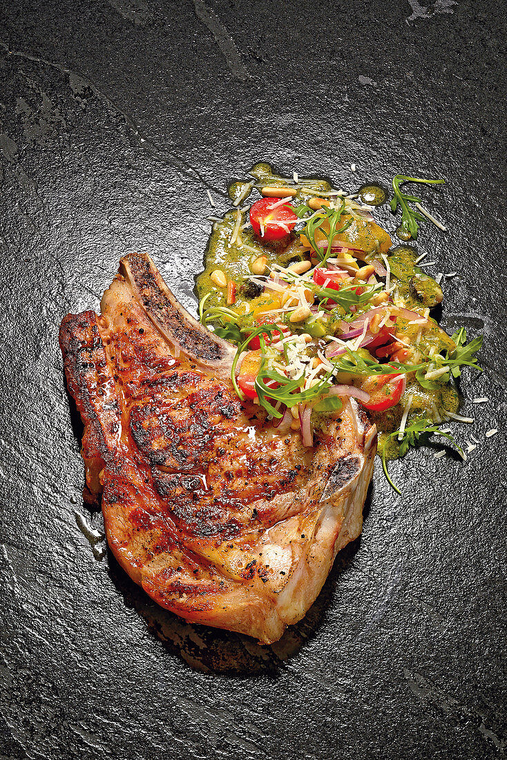 Grilled veal chop with an avocado and orange salad