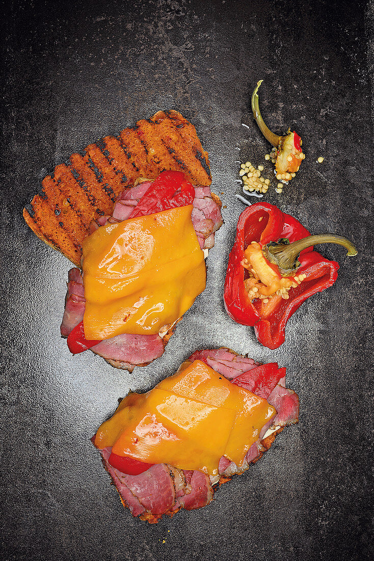 Grilled pastrami sandwiches with peppers and Cheddar cheese