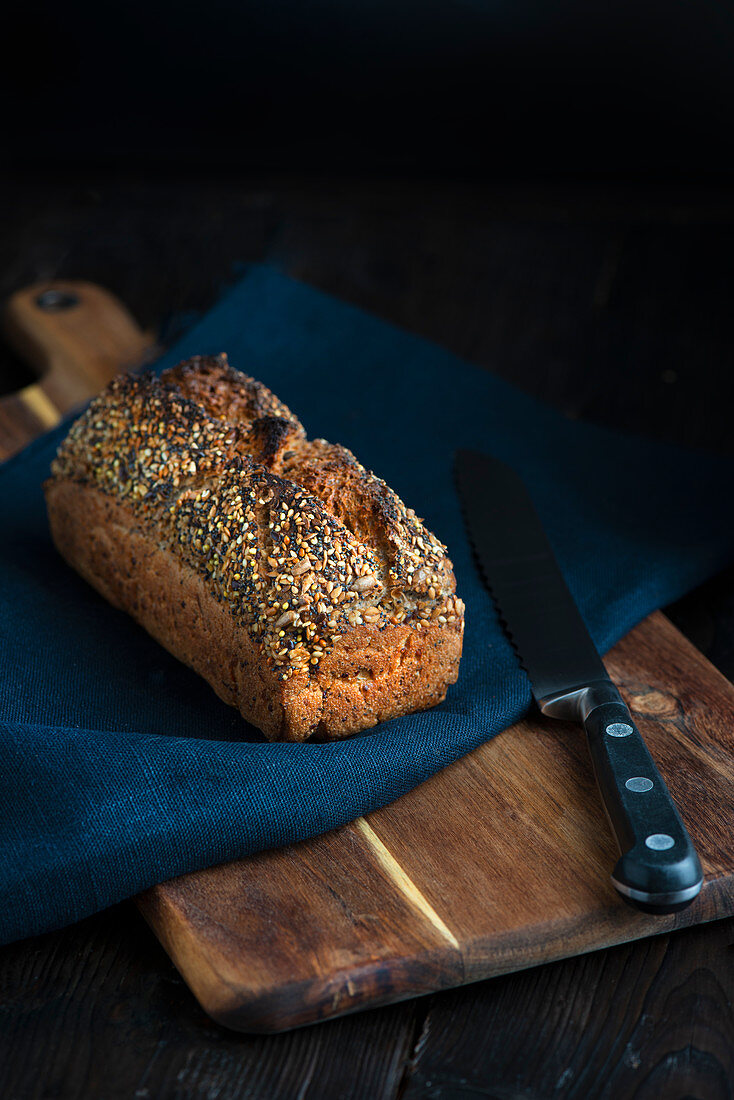 Seed loaf of bread with bread knife