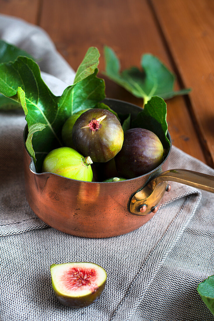Copper pan filled with fresh figs