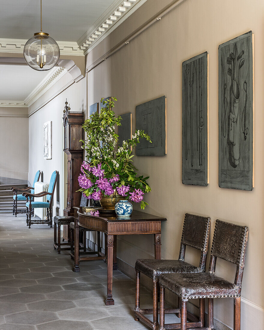 Classic hallway with honeycomb tile floor and antique furniture