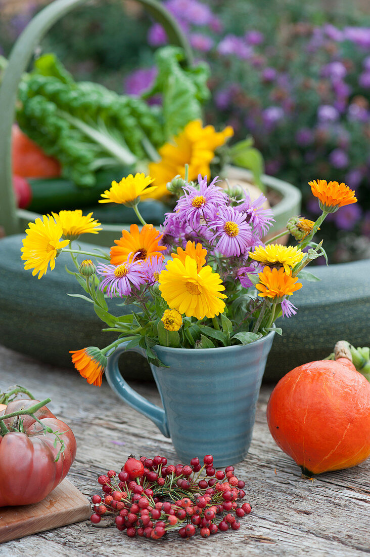 Small autumn bouquet with marigolds and asters, rosehip wreaths