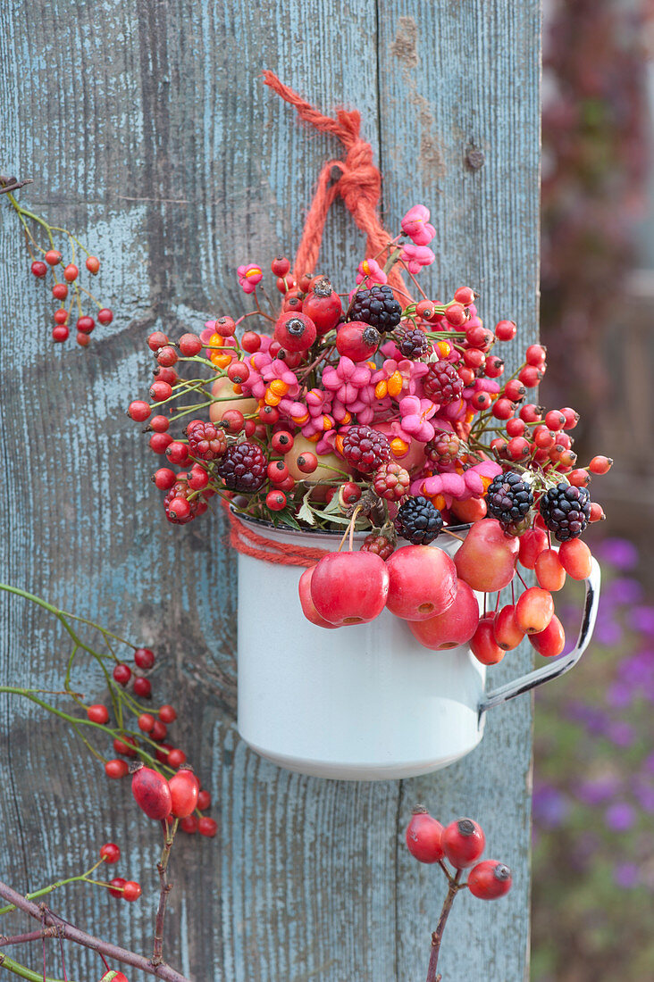 Bouquet of autumn fruits: Rosehips, ornamental apples, blackberries, and common spindle