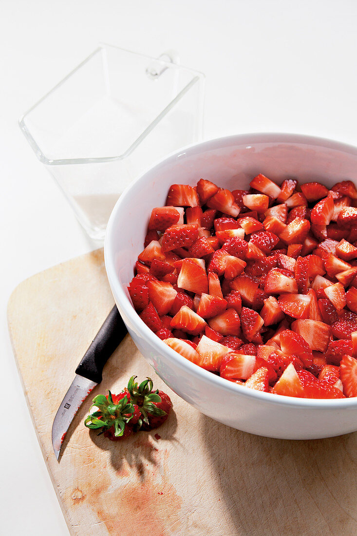 Making jam - cutting strawberries into pieces