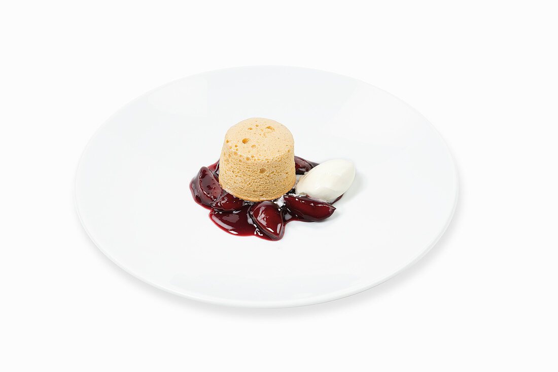 Caramel soufflé with roast plums and sour cream ice cream