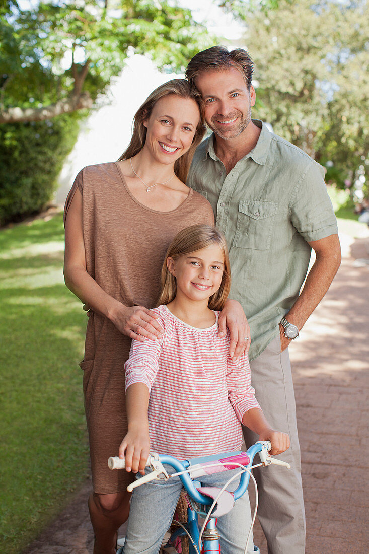 Portrait of smiling parents with daughter