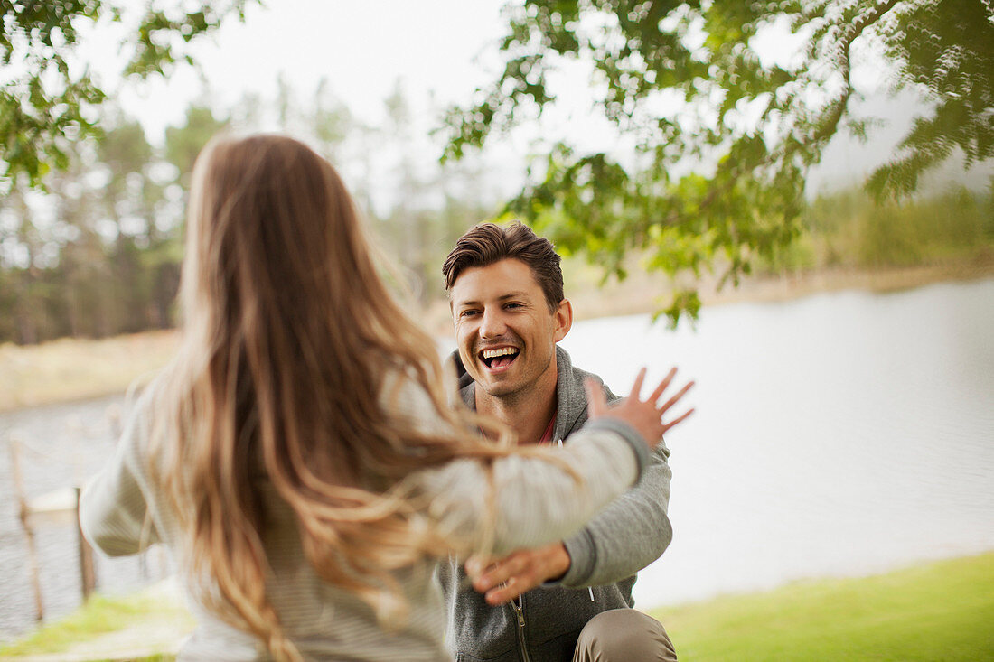 Daughter running toward smiling father