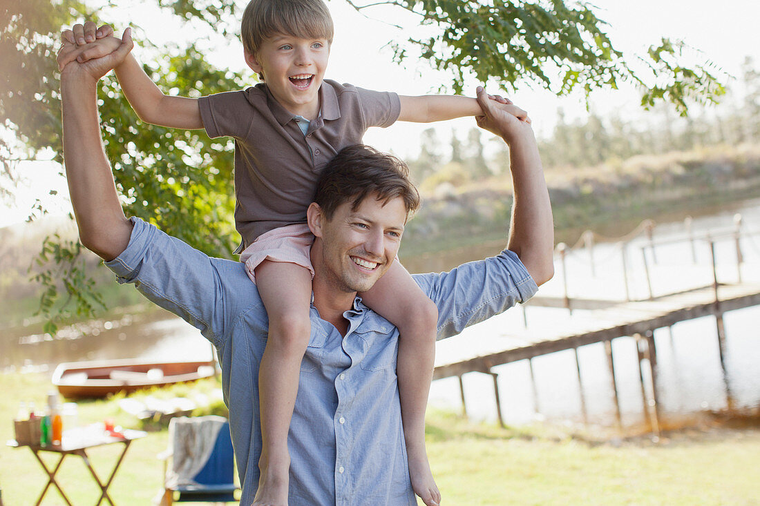 Father carrying smiling son